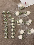 White permanent botanical boutonnieres and corsages